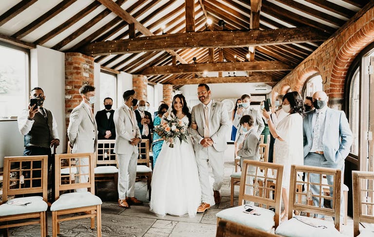 Bride being walked down the aisle by her dad