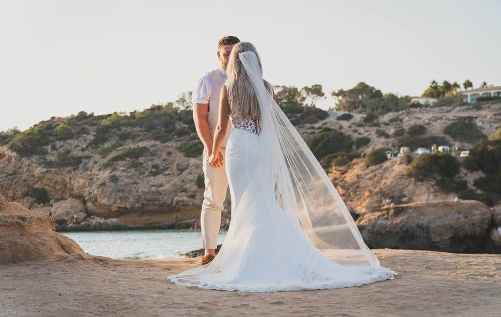 The bride showing off the stunning back detail of Sawyer from The Signature Collection at her Ibiza wedding