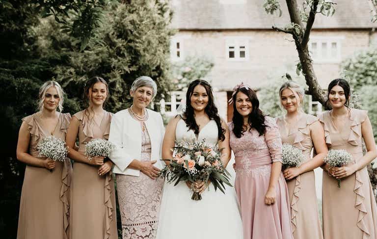 Bride with bridesmaids and family