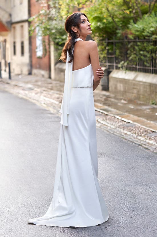 Full length back Image of Giana a modern wedding dress with a halter neckline