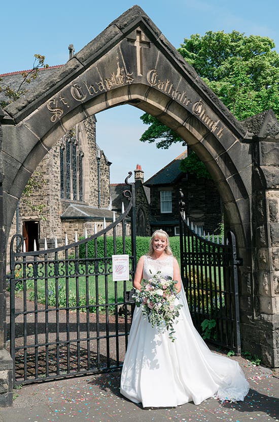 Bride posing in front of the church