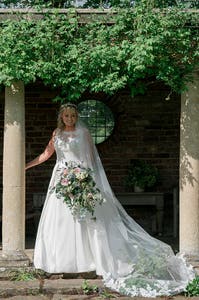 Bride posing at their wedding reception with her bouquet