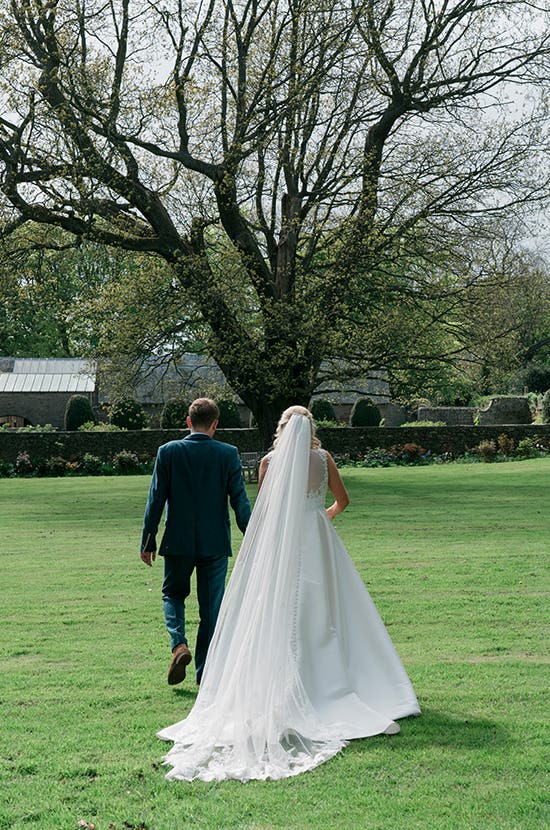 Bride and Groom walking holding hands