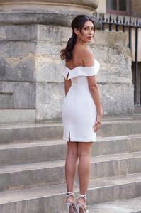 Full length back image of Camilo a striking short wedding dress with off the shoulder straps
