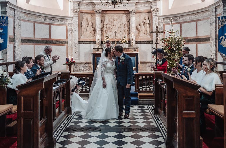 Rhiannon and Edward kissing after their wedding vows