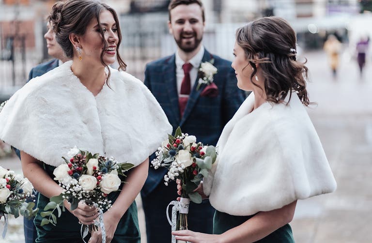 Rhiannon's bridesmaids smiling outside the church