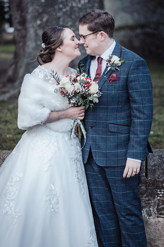 Rhiannon and Edward posing outside while embracing