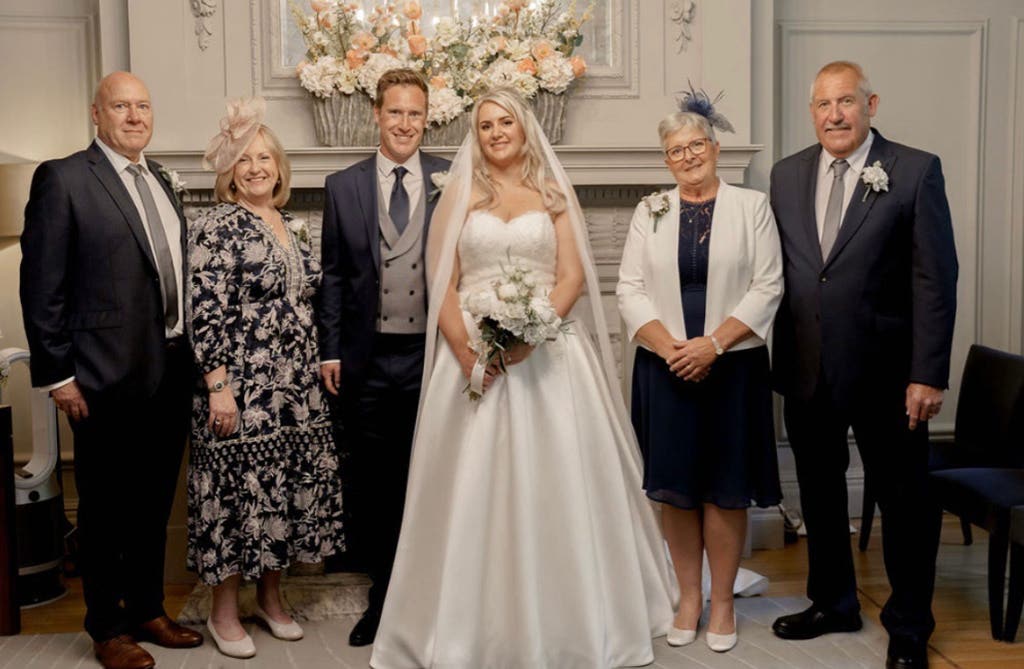 Bride getting ready morning of wedding wearing wedding dress