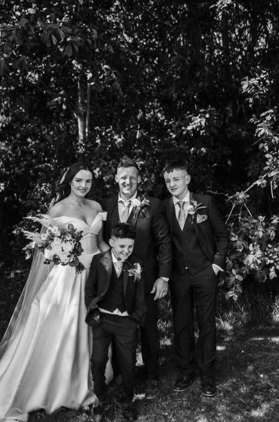 Groom throwing beanbag towards hoop.