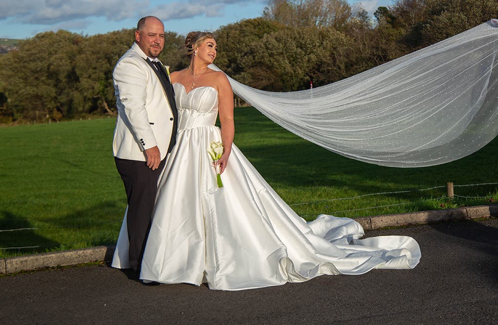 Rachel and Andrew kissing during their hotel wedding ceremony and outdoor portraits