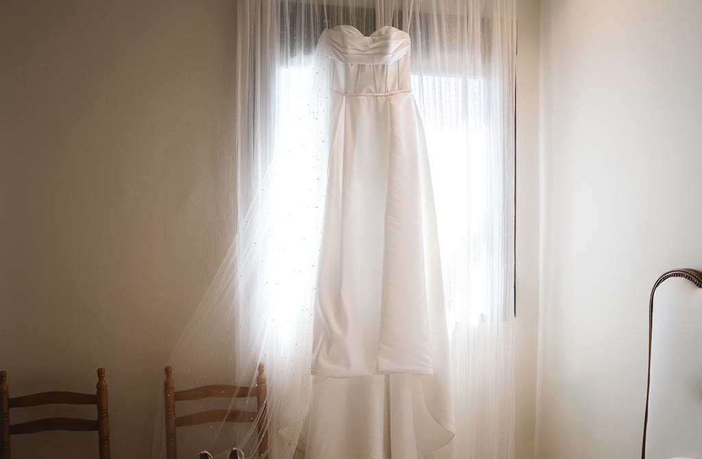Amy’s Mikado A-line wedding dress by wed2b hanging before the ceremony
