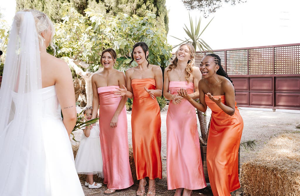 Amy’s bridesmaids reacting as they see her in her wedding dress for the first time