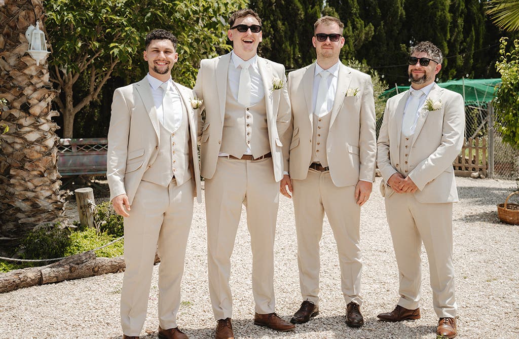 Rob posing in his wedding suit with his groomsmen at the Spanish villa venue