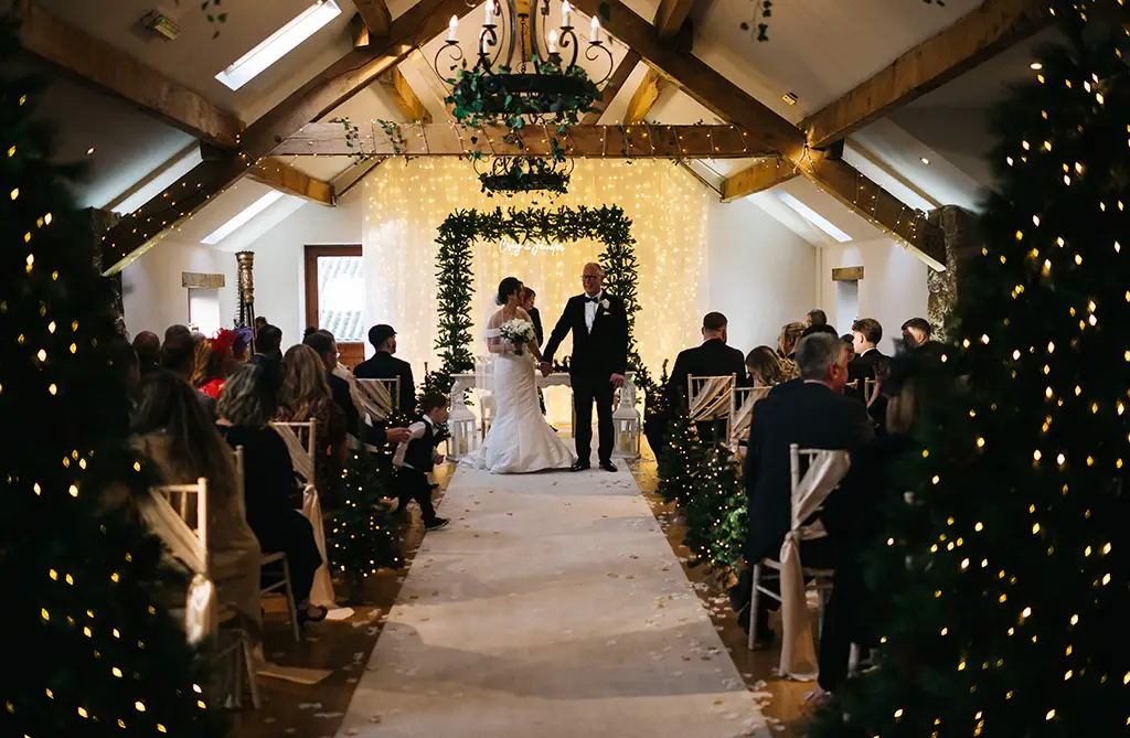 Christmas wedding decor with twinkling lights and festive trees at Beeston Manor