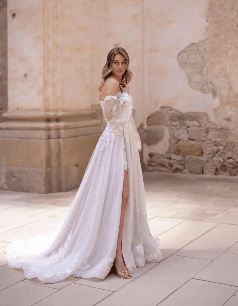 Fashion-forward lace wedding dress with sheer corset bodice and floral detailing