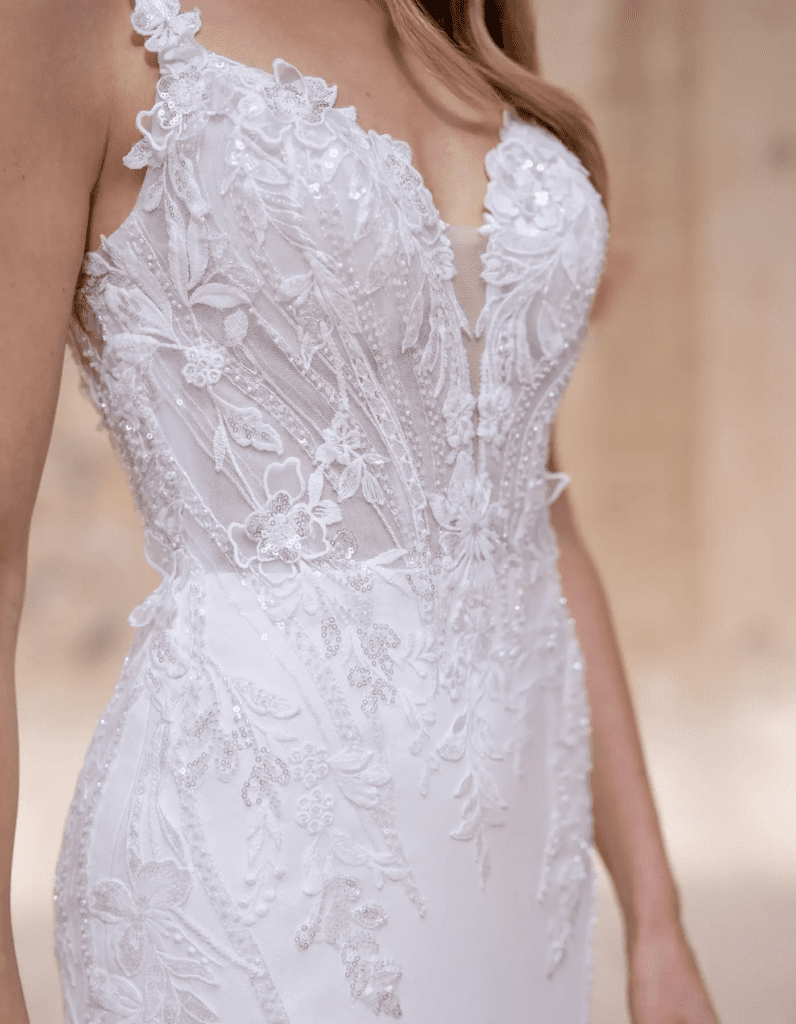 Modern lace bridal gown with 3D floral appliqué and fitted silhouette