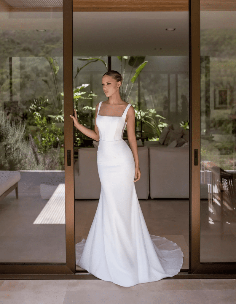 Contemporary fashion-forward wedding dress with square neckline and sleek design