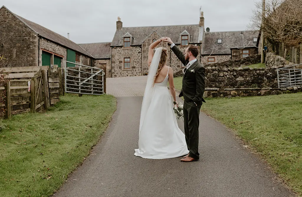 Becky wearing Alber by Sofia Cruz with modern cowl neckline and pearl accessories