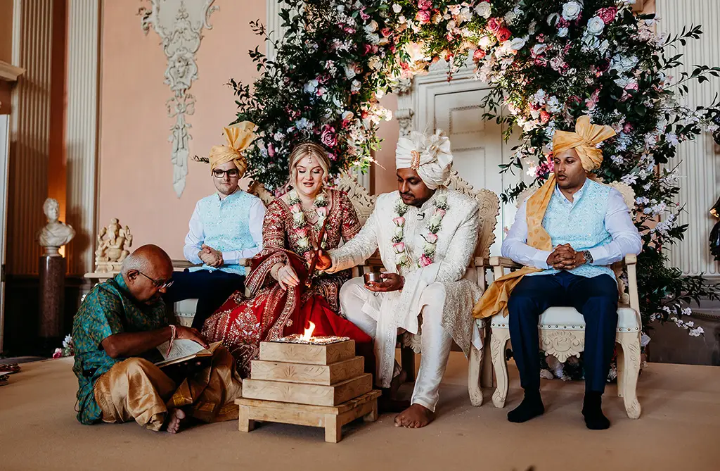Fran and Ronit in traditional Indian attire during their Hindu wedding ceremony