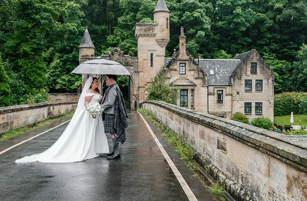 Joanna and Joseph outside on their rainy wedding day