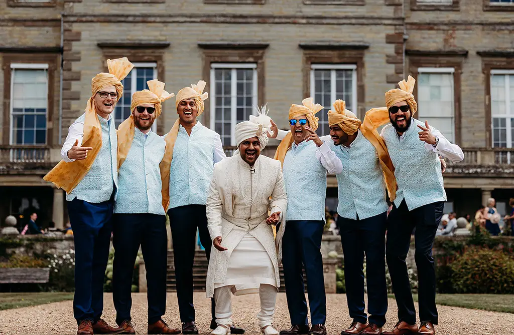 Ronit in traditional Indian wedding attire with his groomsmen outside Ragley Hall