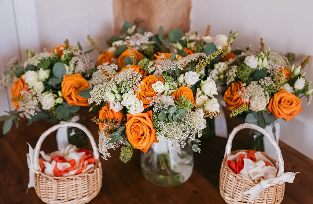 Jodie and Oliver’s bridesmaids’ bouquet with orange roses