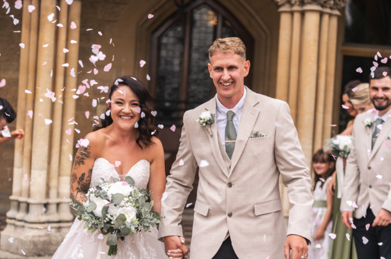 Lauren's brother walking her down the aisle at her garden wedding