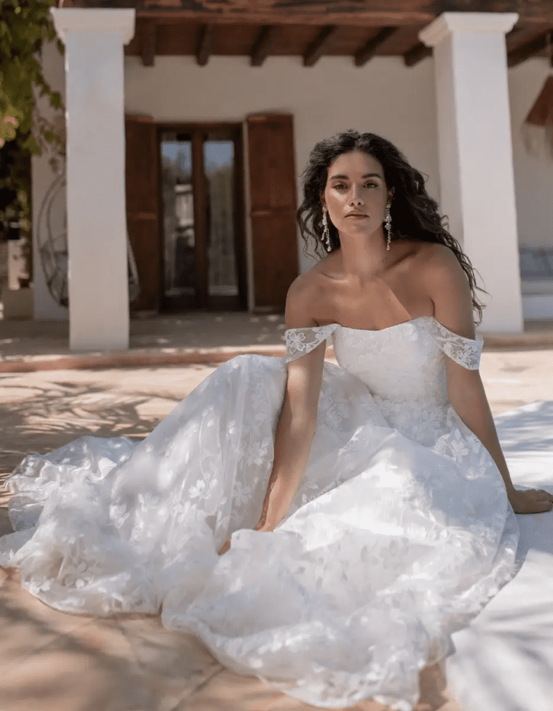 Bride wearing Dena, a lace wedding dress by Heidi Hudson