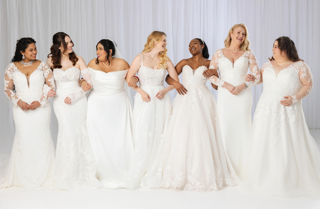 Bridal Expert helping a bride try on a wedding dress in store