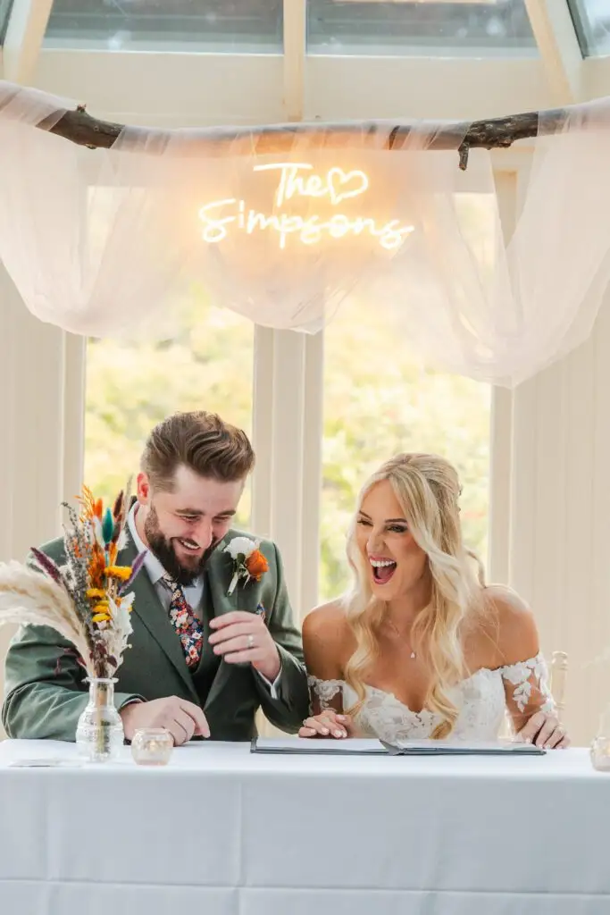 Jaynie and Jack laughing at their Autumn wedding